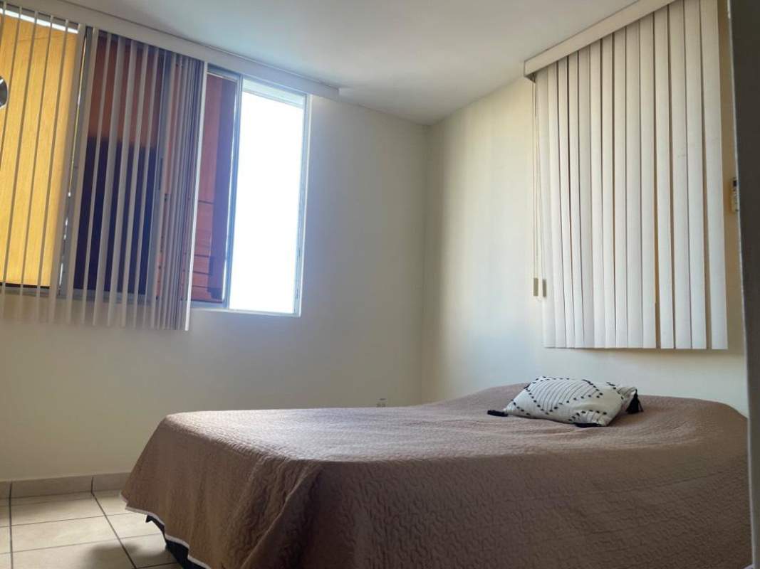 Bright bedroom with window and tiled floor in PH Plaza Valencia Carrasquilla Panama