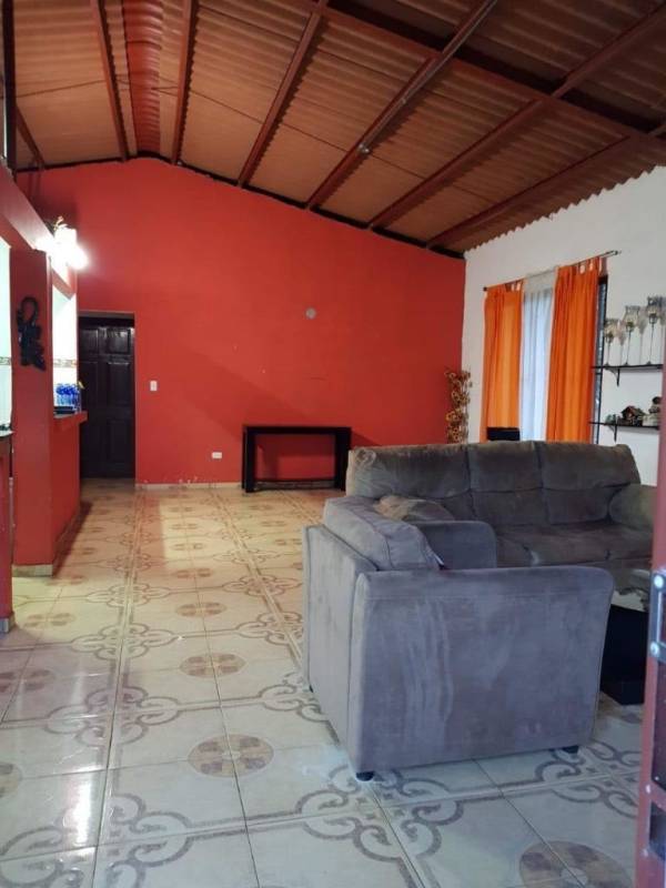 Bedroom with wardrobe ceiling fan orange walls rural house Pacora Panama