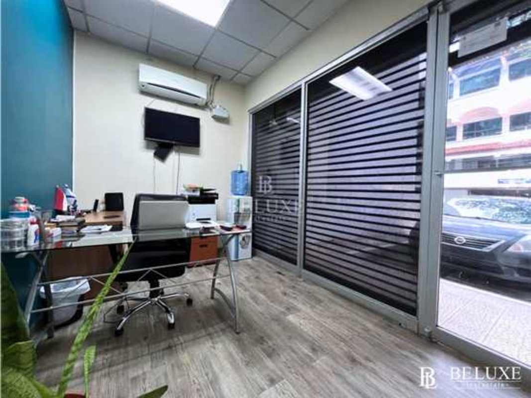 Bright functional meeting room with glass desks, whiteboard in commercial office Panama City Calle 50