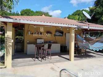 Modern kitchen with granite countertops, refrigerator, water dispenser, and stove in San José San Carlos Panama