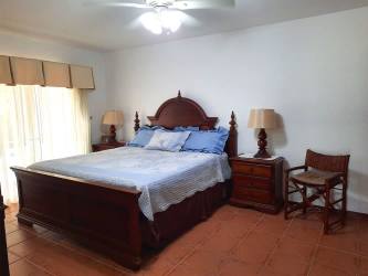 Bedroom with vaulted ceiling exposed beams double beds garden view Villas Decameron Rio Hato Panama