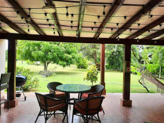 Covered patio with dining area fenced lush garden hammock Villas Decameron Rio Hato Panama