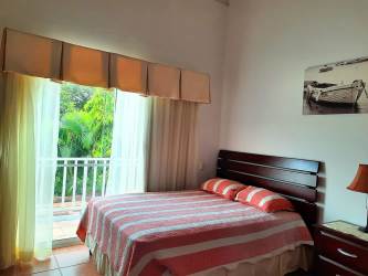 Coastal bedroom with vaulted ceilings AC closet exposed beams beach golf villa Decameron Farallón Panama