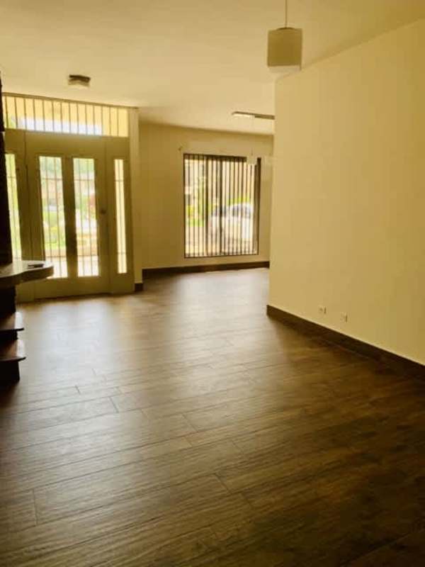 Bright living room with large windows, tile floors, terrace access in Clayton