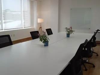 Training room with whiteboards, large windows, red chairs, smart screen in Costa Verde Business Hub Panama