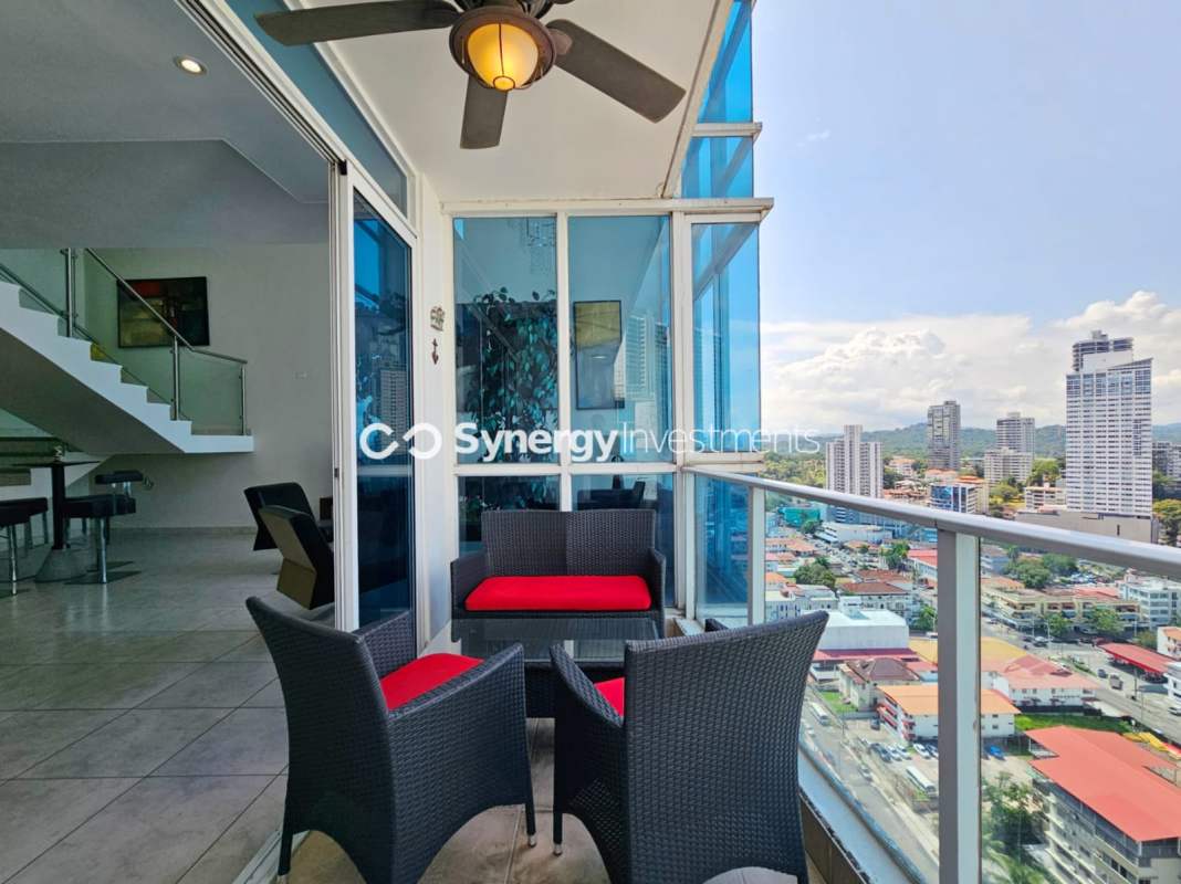 Large custom walk-in closet with wood cabinetry in luxury penthouse PH Waters on the Bay Panama City