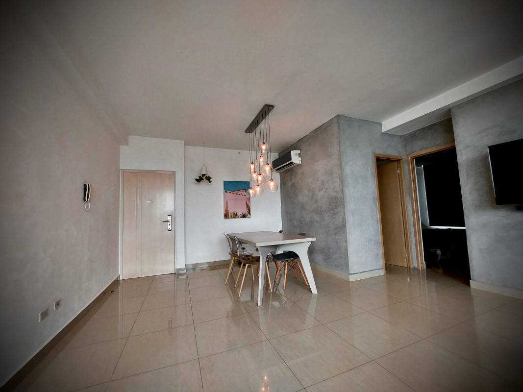 Minimalist dining room with pendant lights and concrete wall PH South Coast Panama
