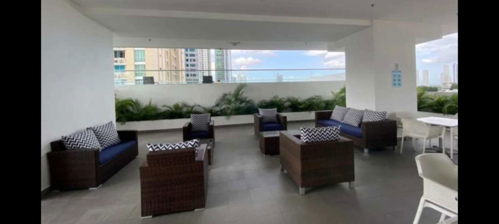 Outdoor lounge terrace with wicker furniture and skyline view PH South Coast