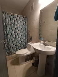 Modern kitchen with laundry space, microwave and fridge in PH Natura Costa Verde Panama