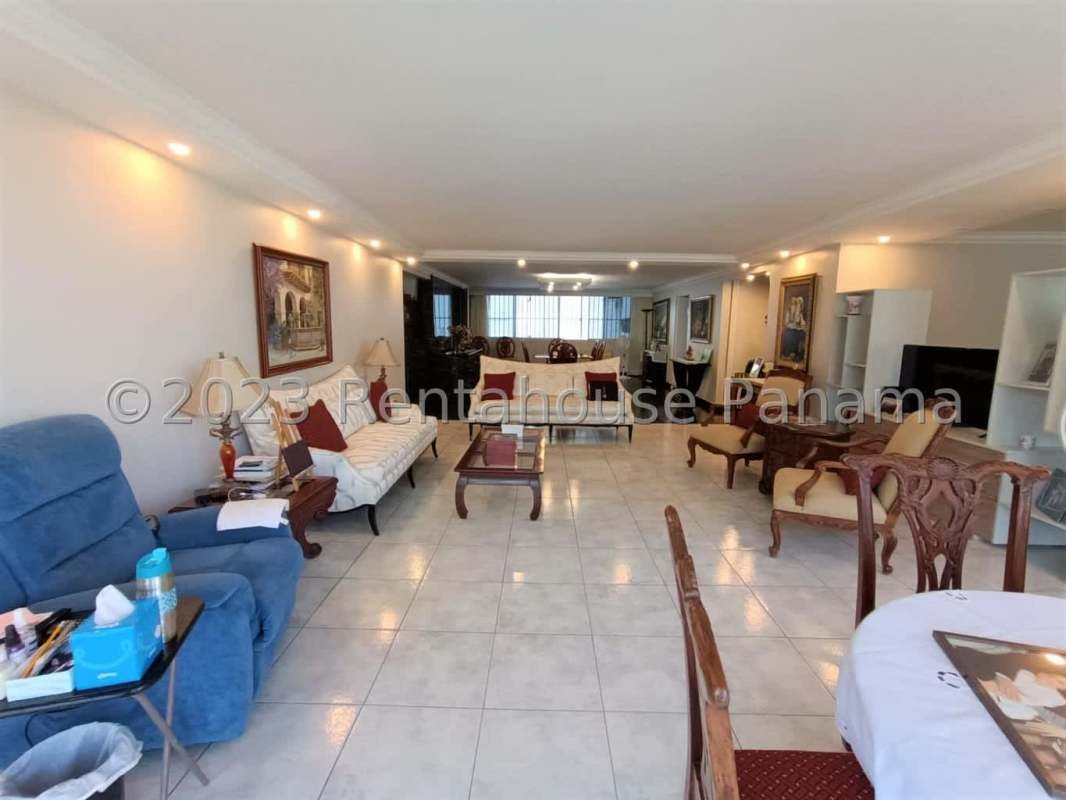 Traditional dining room with glass table, wooden chairs, marble floor in PH Fiesta Obarrio Panama City