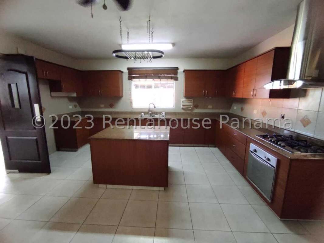 Modern kitchen with center island, granite countertop, wooden cabinets PH Castel Novo Panama