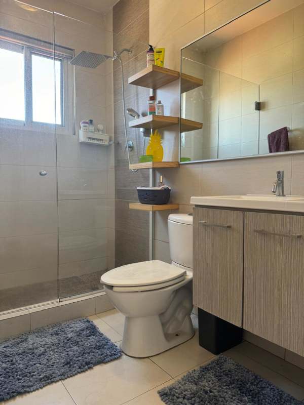 Dining and living room with large glass doors to backyard Costa Sur Panama