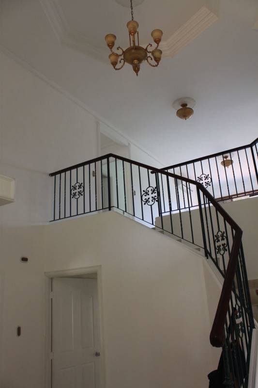 Grand curved staircase with decorative iron railings in upscale Costa Azul home Panama