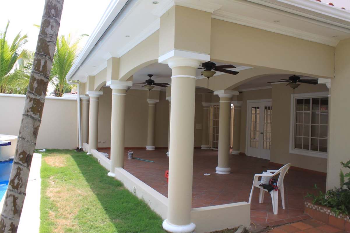 Covered terrace with decorative arches, ceiling fans and views of private swimming pool Costa del Este Panama