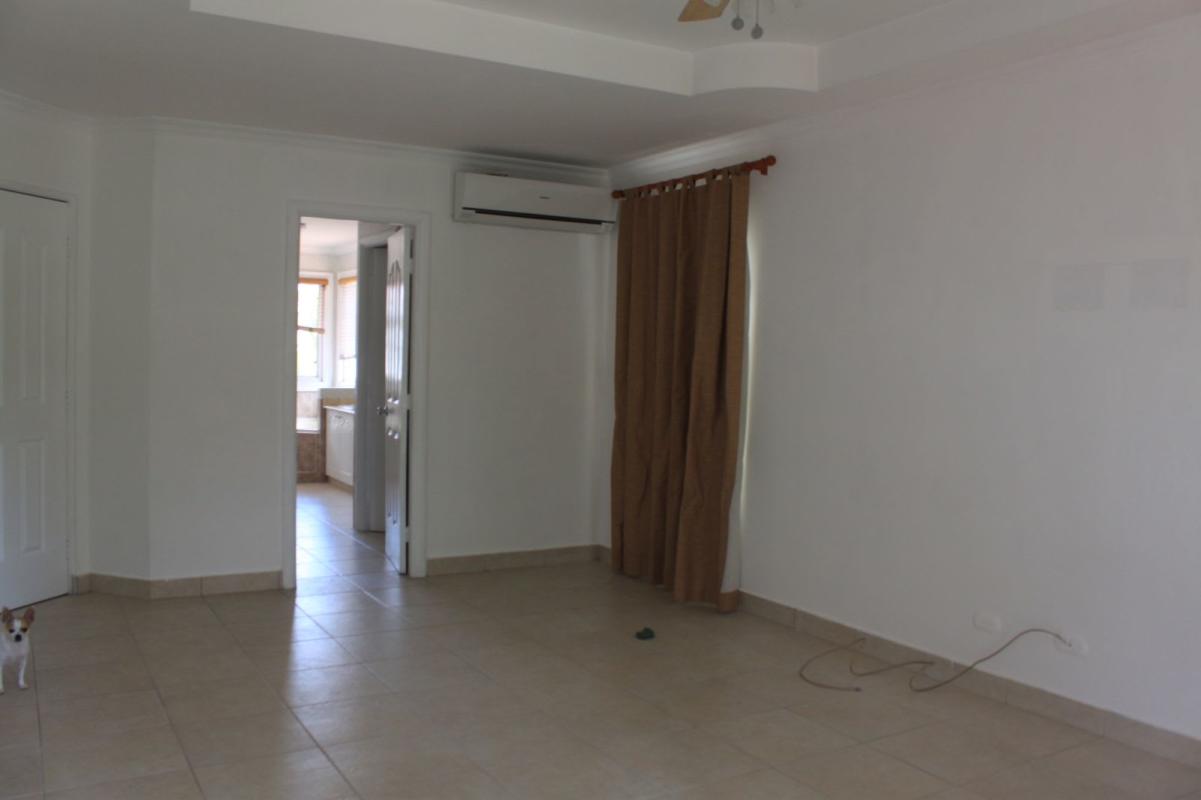 Living area with tiled floor, AC, curtain window, and neutral colors in Costa Azul Costa del Este