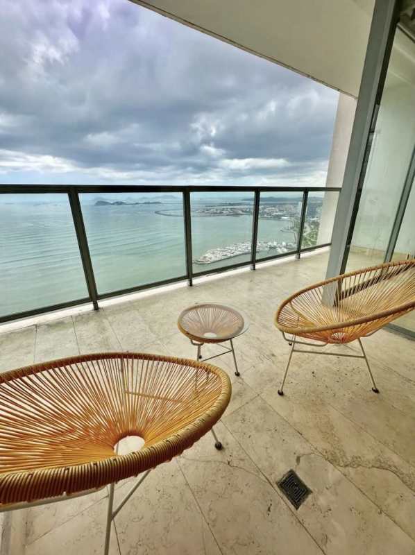 Luxury living room with floor-to-ceiling glass, balcony overlooking Pacific Ocean in PH Yoo Panama