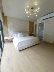 Bright living room with mezzanine, glass railings and open floor plan in Panama Pacifico house