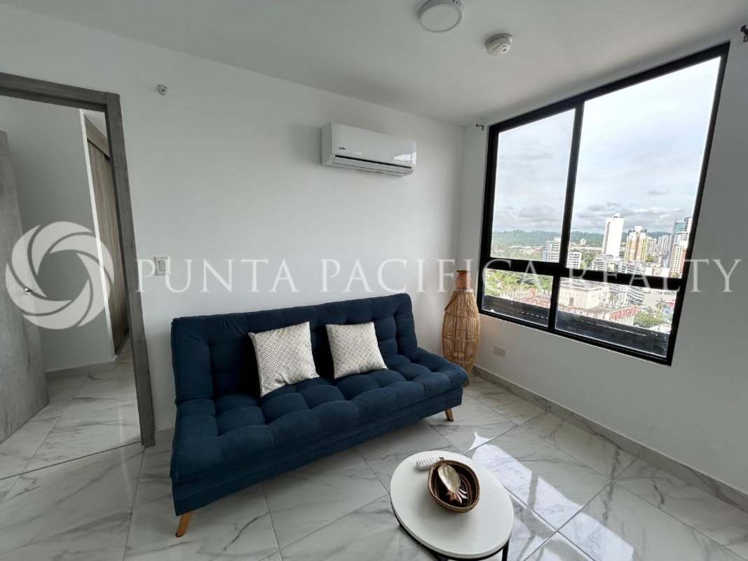 Bright living room with large windows and city view in The Gray Obarrio Panama City
