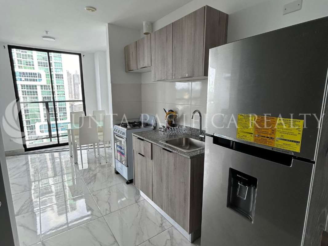 Modern kitchen with granite counters, stainless fridge, gas stove in The Gray Calle 50 Panama