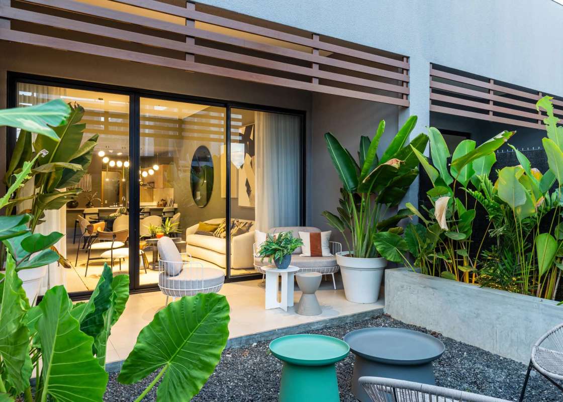 Master bedroom in Imaterra townhouse featuring large windows, balcony access and modern finishes at Panama Pacifico