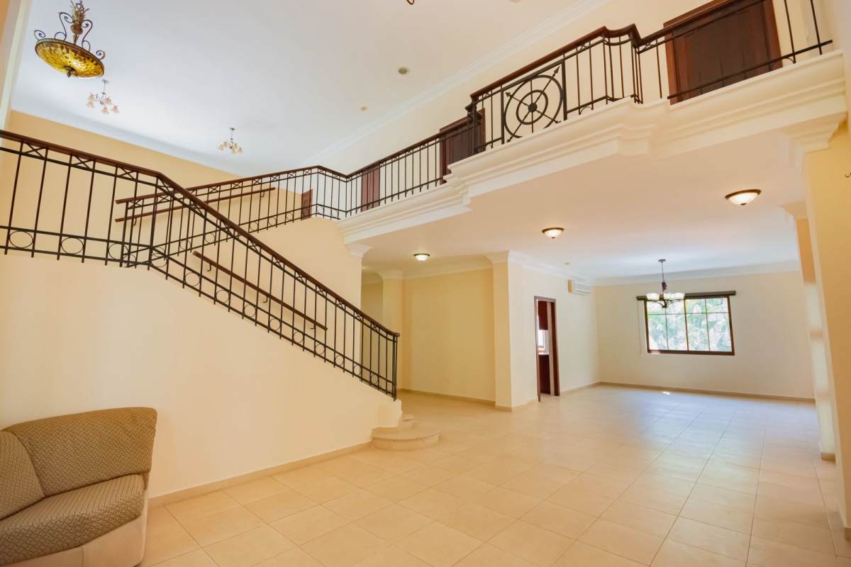 Spacious living room with high ceiling, chandelier, stairs, Camino de Cruces