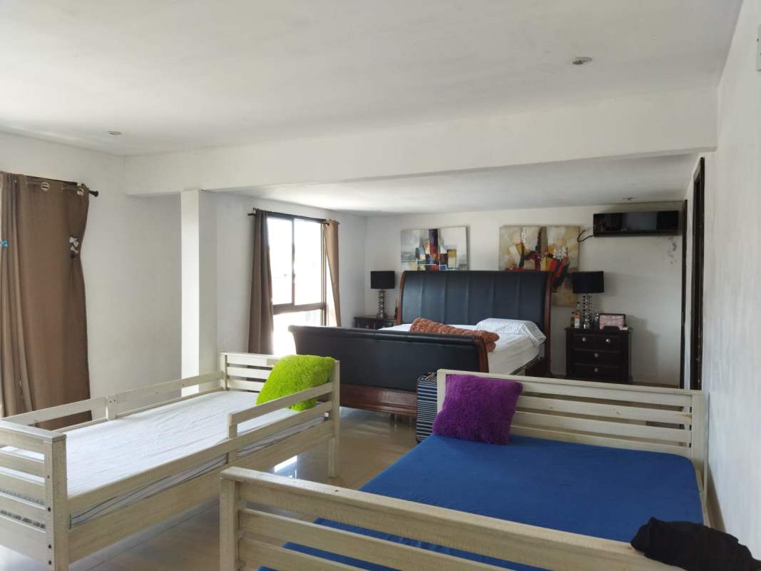 Bright living room with tile floors, natural light and terrace view in El Dorado Panama home