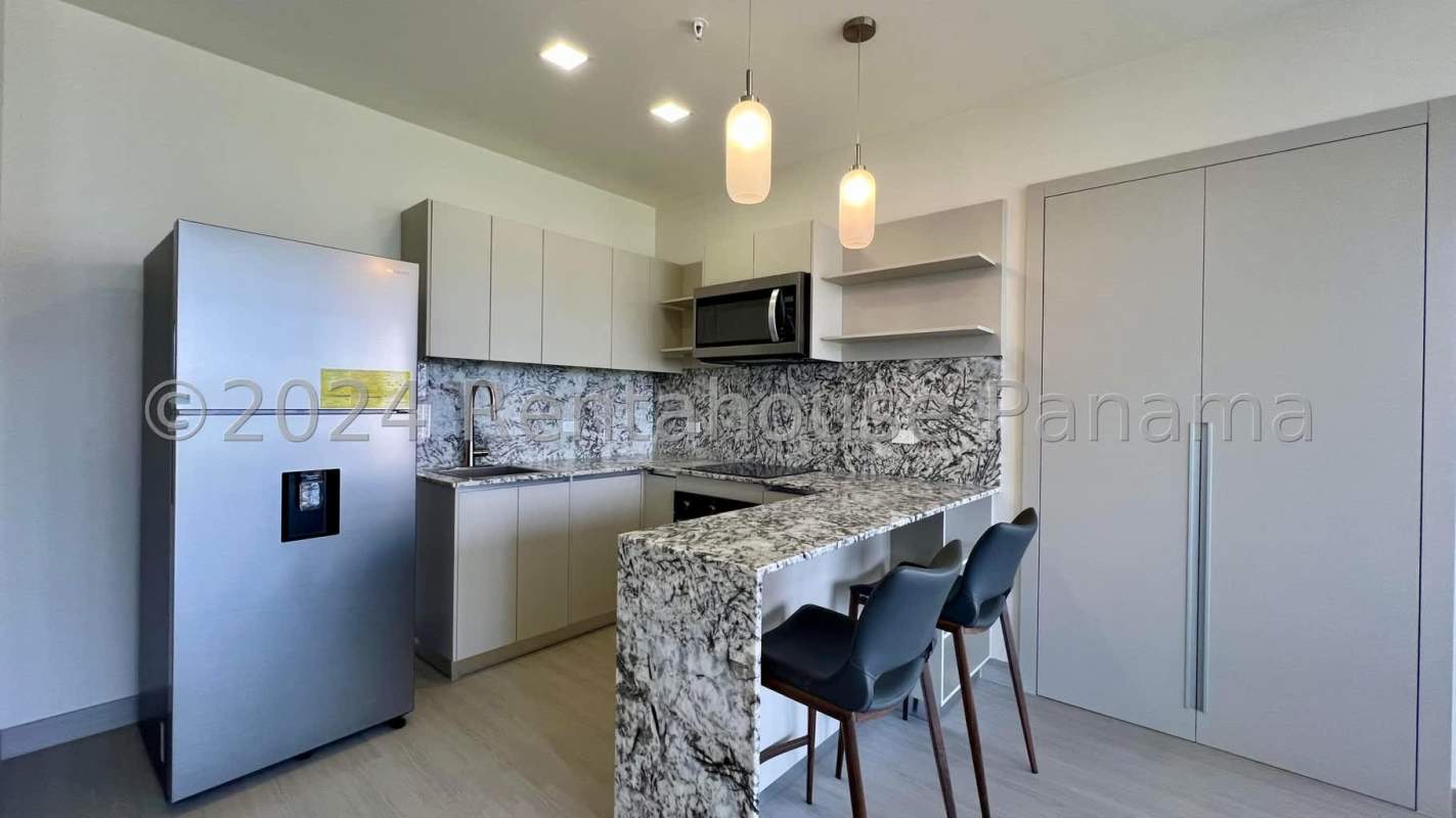 Kitchen with granite countertop, bar, stainless appliances in PH Arcadia Costa del Este Panama
