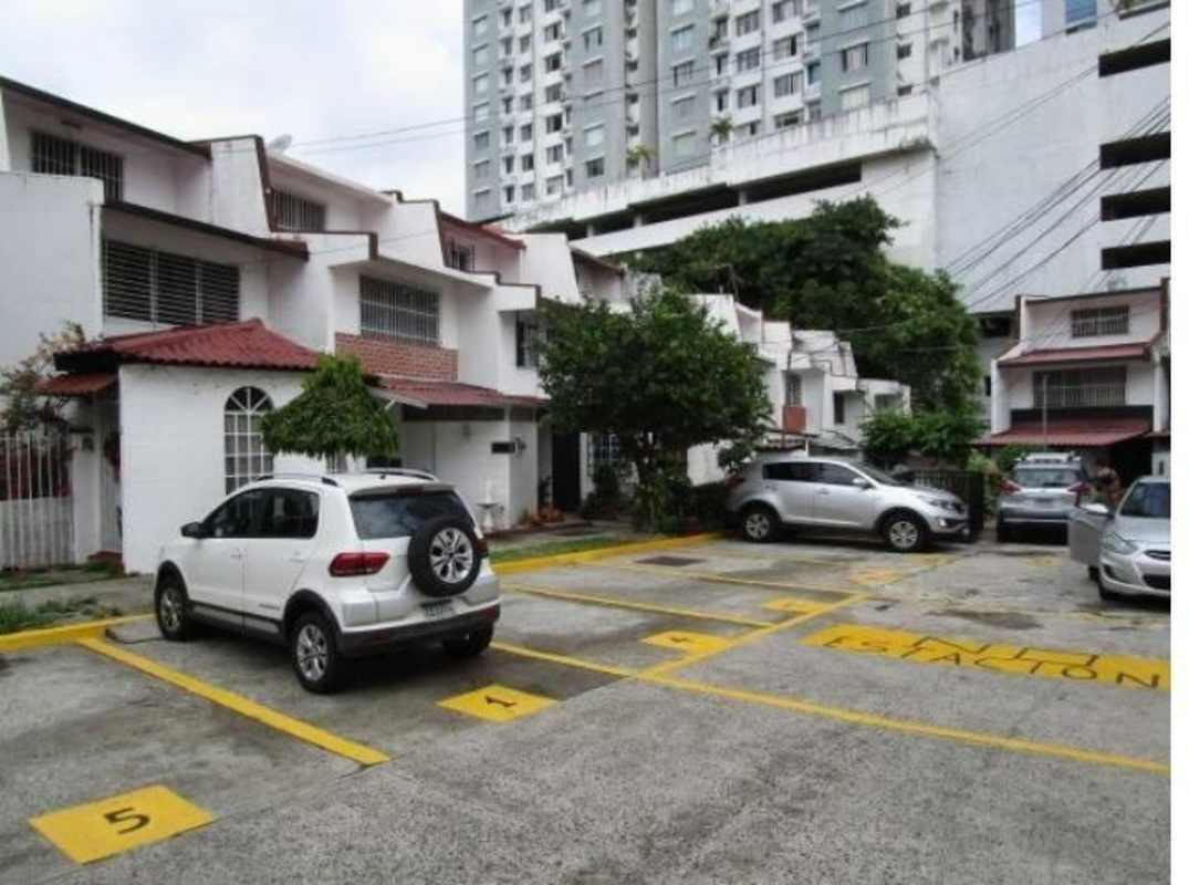 Parking area with townhouses and greenery in Carrasquilla Panama City