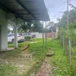 Two white houses on large fenced green lot with fruit trees Santa Rita Coclé Panama