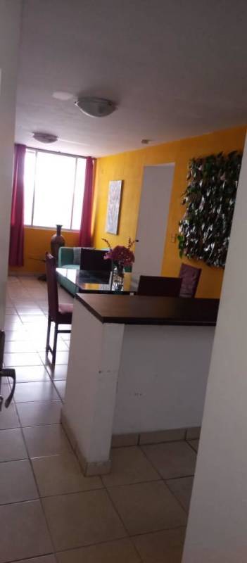 Open living dining space, tiled floors, large window at PH Vía España, Obarrio Panama