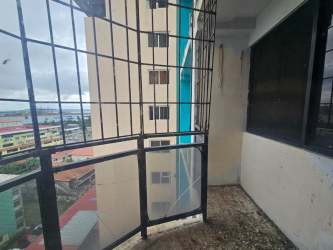 Spacious living room with tiled floor and ocean-facing window PH Ocean Plaza Colón Panama