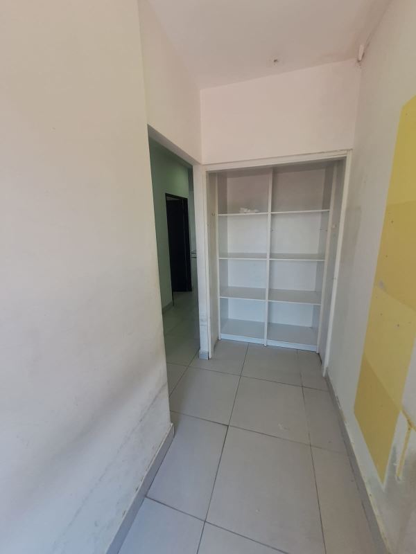 Hallway with shelf and tiled floor at commercial space Plaza San Francisco Panama