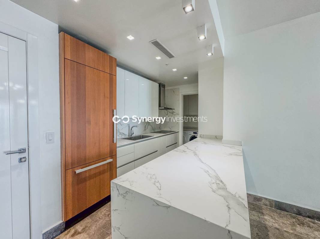 Luxury remodeled Italian Poliform kitchen with marble countertops and built-in appliances in YOO Panama apartment