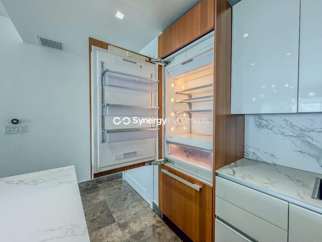 Open plan living room with marble floors, ocean views, and modern finishes at YOO Panama apartment for sale