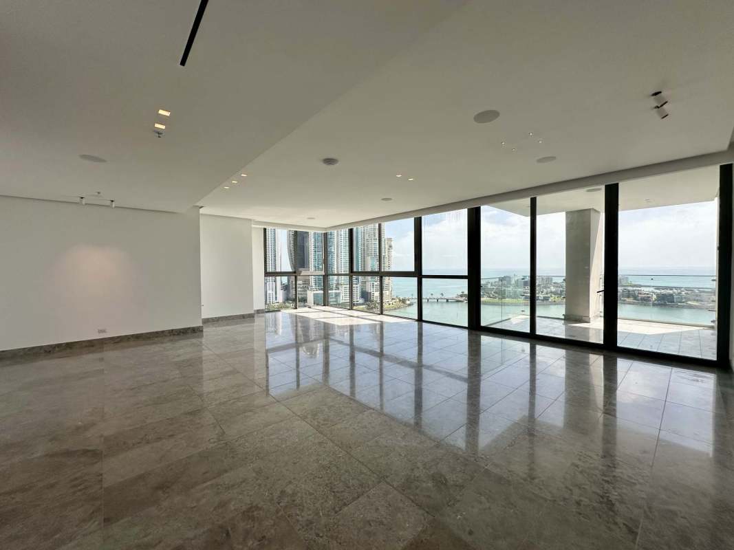 Spacious living area with floor-to-ceiling windows and ocean views at PH Sea Point Punta Paitilla Panama City