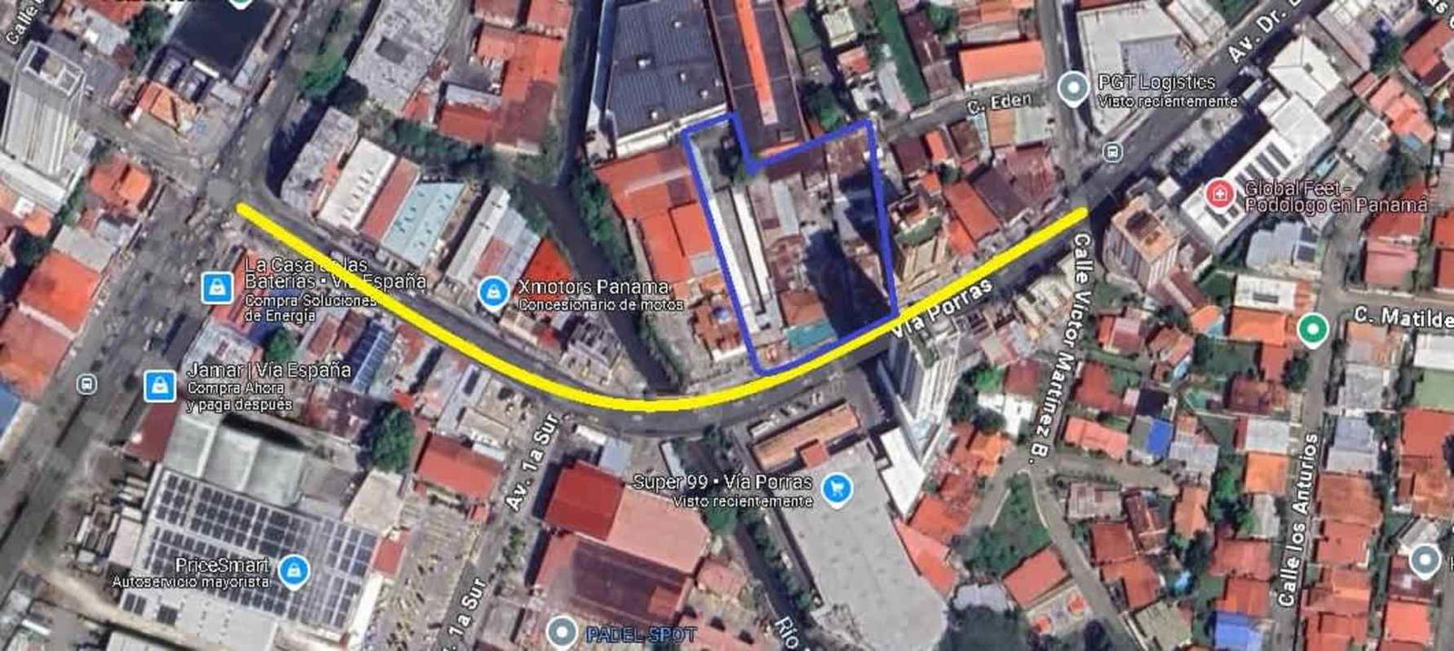 Multistory mixed-use building with storefronts and delivery truck at Vía Porras Panama City