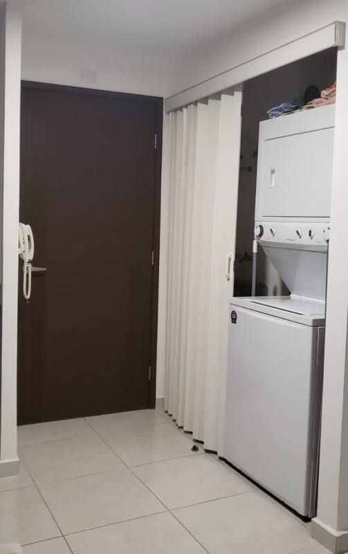 Compact laundry closet with washer dryer in apartment PH BICSA Tower Panama City