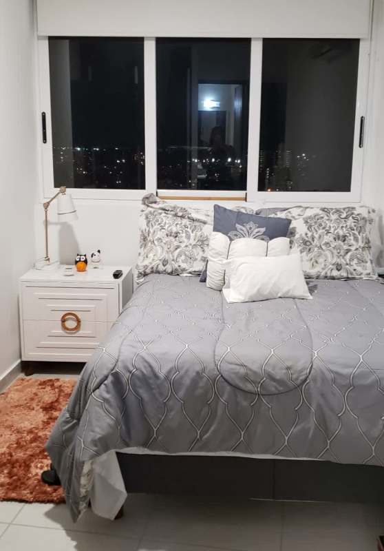 Living-dining area with floor-to-ceiling glass, balcony, ocean and city view PH BICSA Avenida Balboa Panama