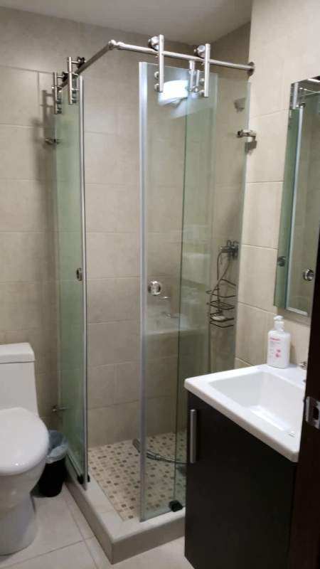 Modern bathroom with glass shower, pedestal sink, tile PH BICSA Panama City