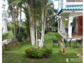 Beautiful garden with palm trees and covered patio Mediterranean villa Playa Blanca Panama