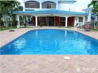 Two-story Mediterranean villa with blue tile roof and private swimming pool Playa Blanca Resort Panama