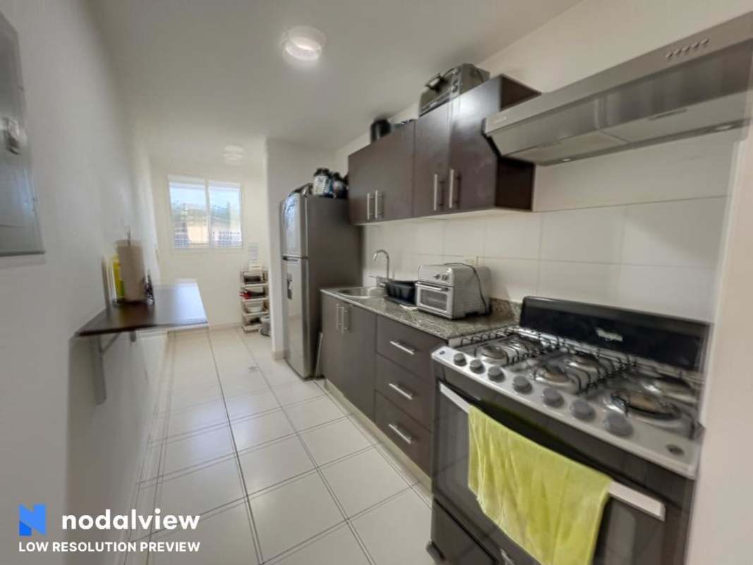 Apartment kitchen with granite countertop, cabinets and appliances in Villa Lucre Panama City