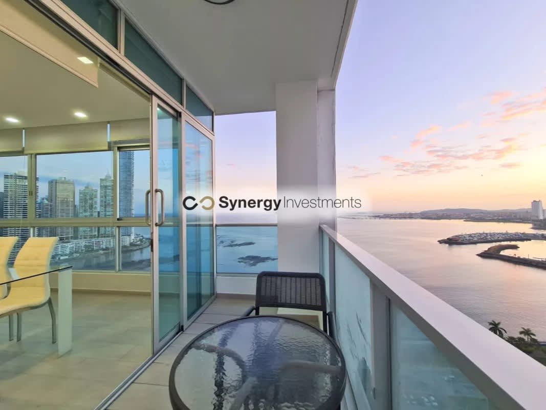 Spacious living area with floor-to-ceiling windows and panoramic ocean views in Yacht Club Tower Panama City