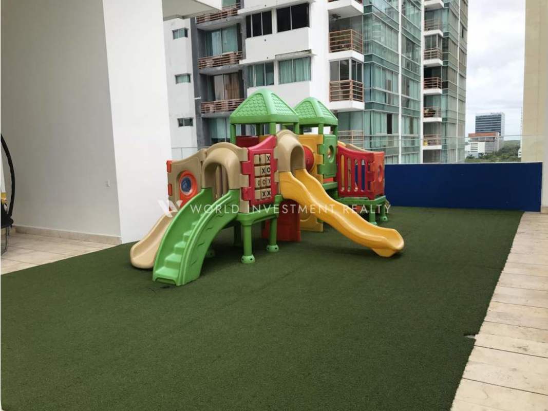 Safe children’s play area with artificial turf and colorful equipment PH Top Tower