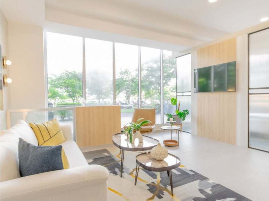 Modern lobby with natural light, reception desk, lounge seating in Seaside Tower Bella Vista