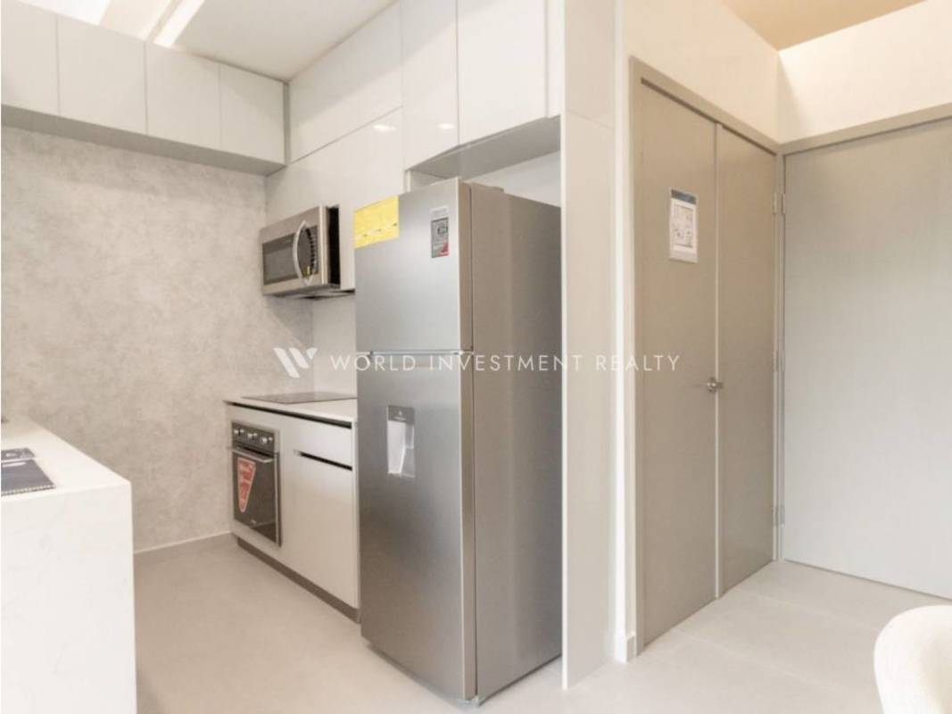Fully equipped kitchen with white cabinetry, stainless appliances, minimalist design Seaside Tower Panama