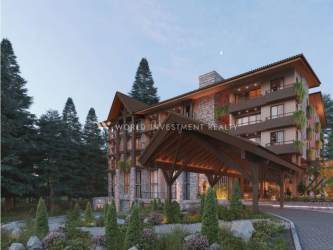 Entrance of rustic multi-story mountain lodge with balconies and pine trees Pino Alto Residences Boquete Panama