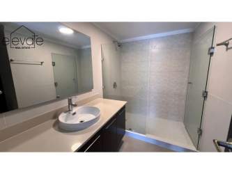 Bathroom with glass shower, vanity sink in PH Mosaic apartment, Panama Pacifico