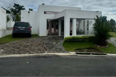 Modern white minimalist villa with driveway, carport and garden at Ibiza Residences 1 Río Hato Panama