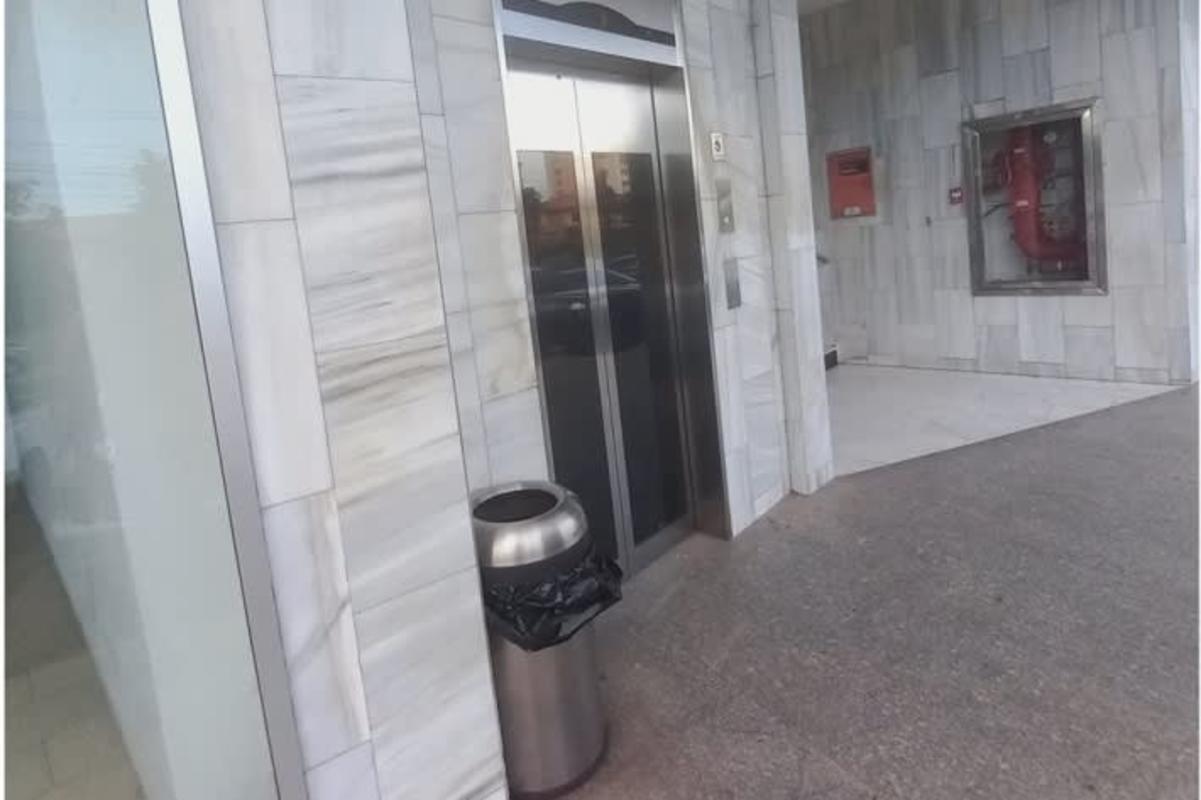 Building lobby area with elevator and marble wall finish at Plaza Versalles Costa del Este Panama City